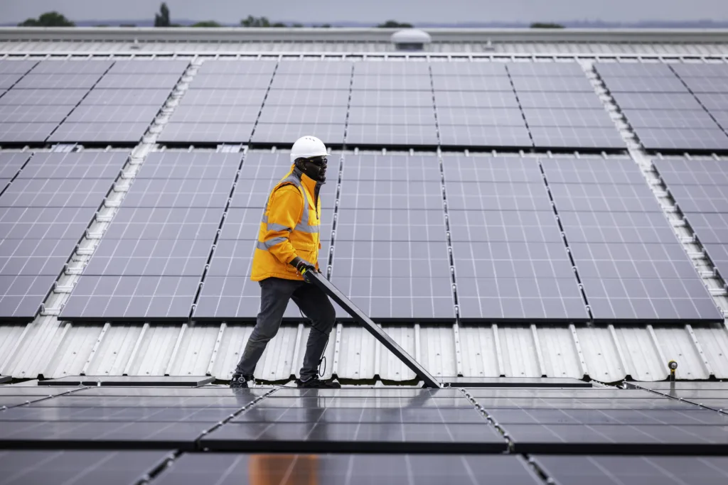 Custom Solar engineer holding a PV panel