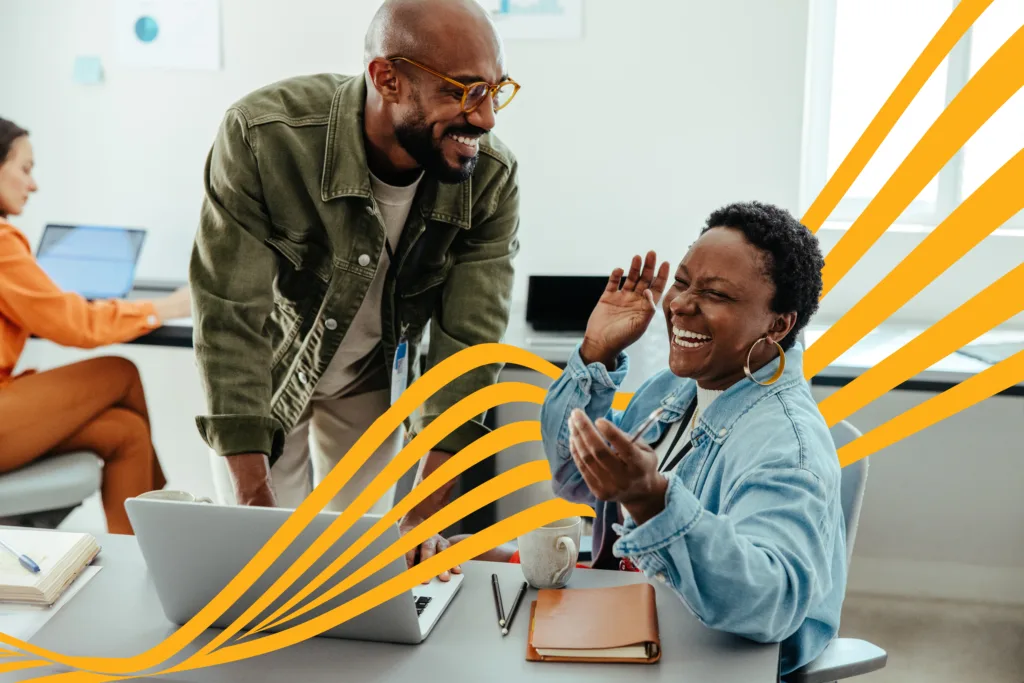 Two people laughing in an office with yellow wavy lines between them