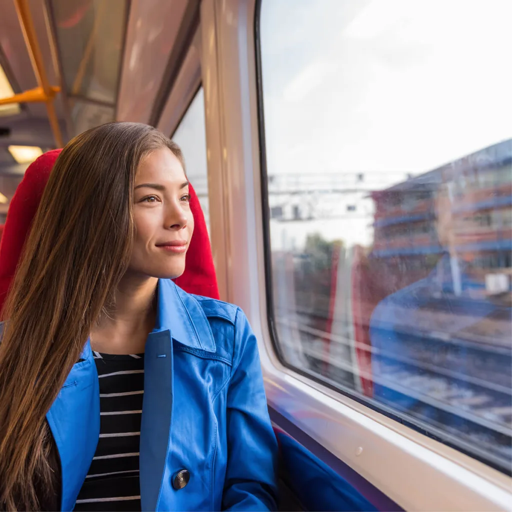 Female rail passenger smiling