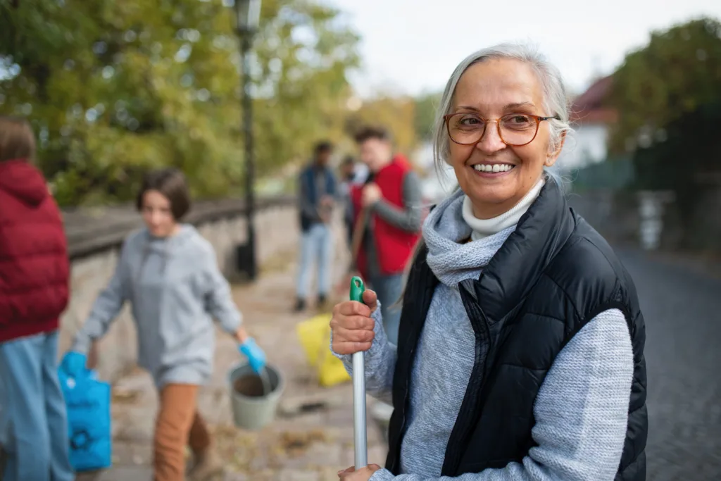 Smiling woman volunteering outside