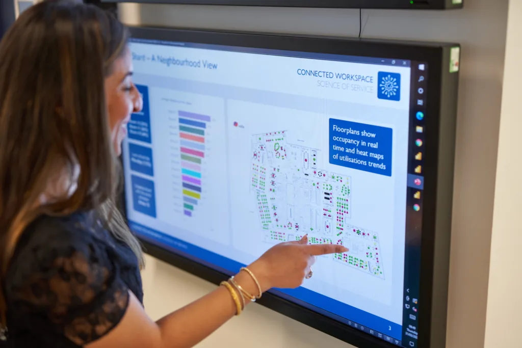 Employee using a digital office interface for booking a desk