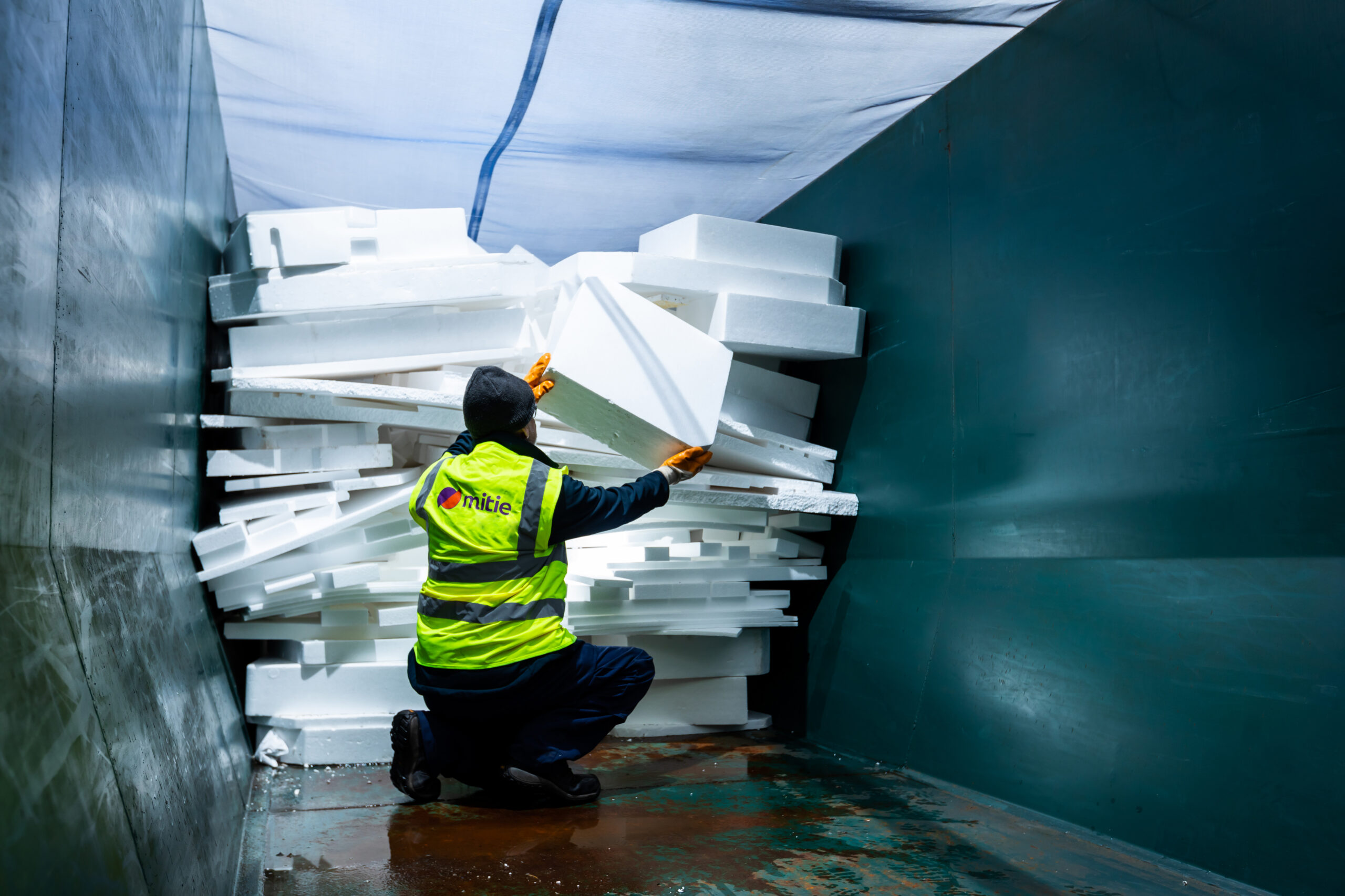 Mitie colleague loading waste into a van