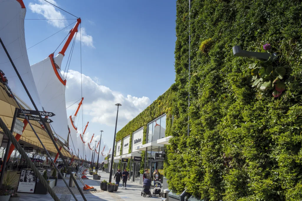 The exterior of a building with a living green wall, created by Biotecture