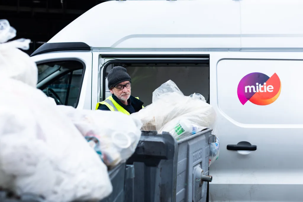 Mitie colleague collecting waste bins