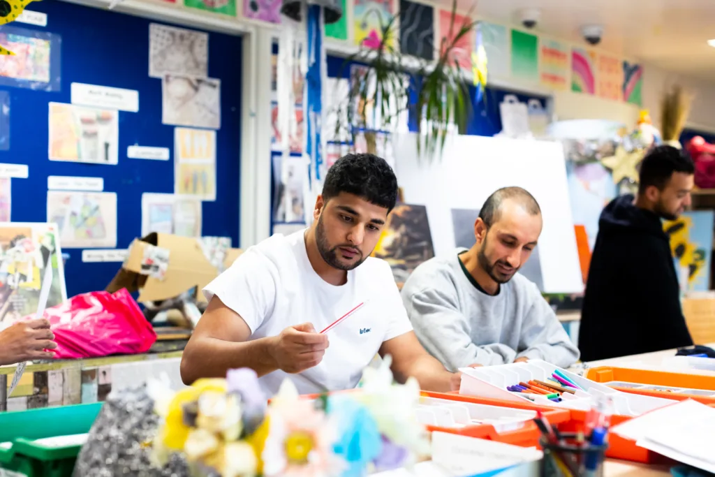 People doing art at an immigration centre