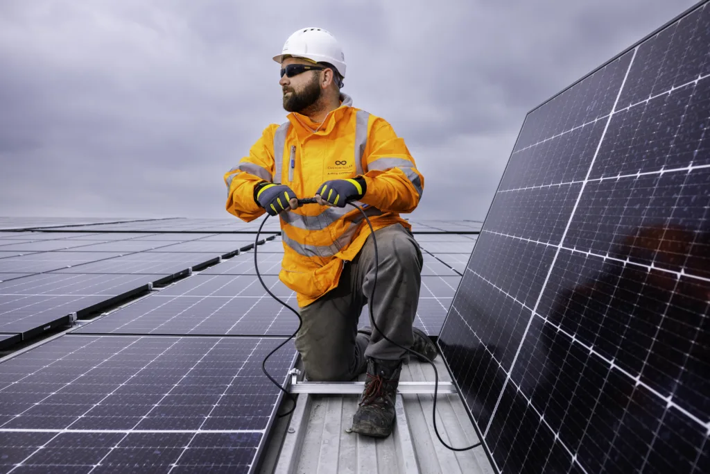 Custom Solar engineer installing a panel