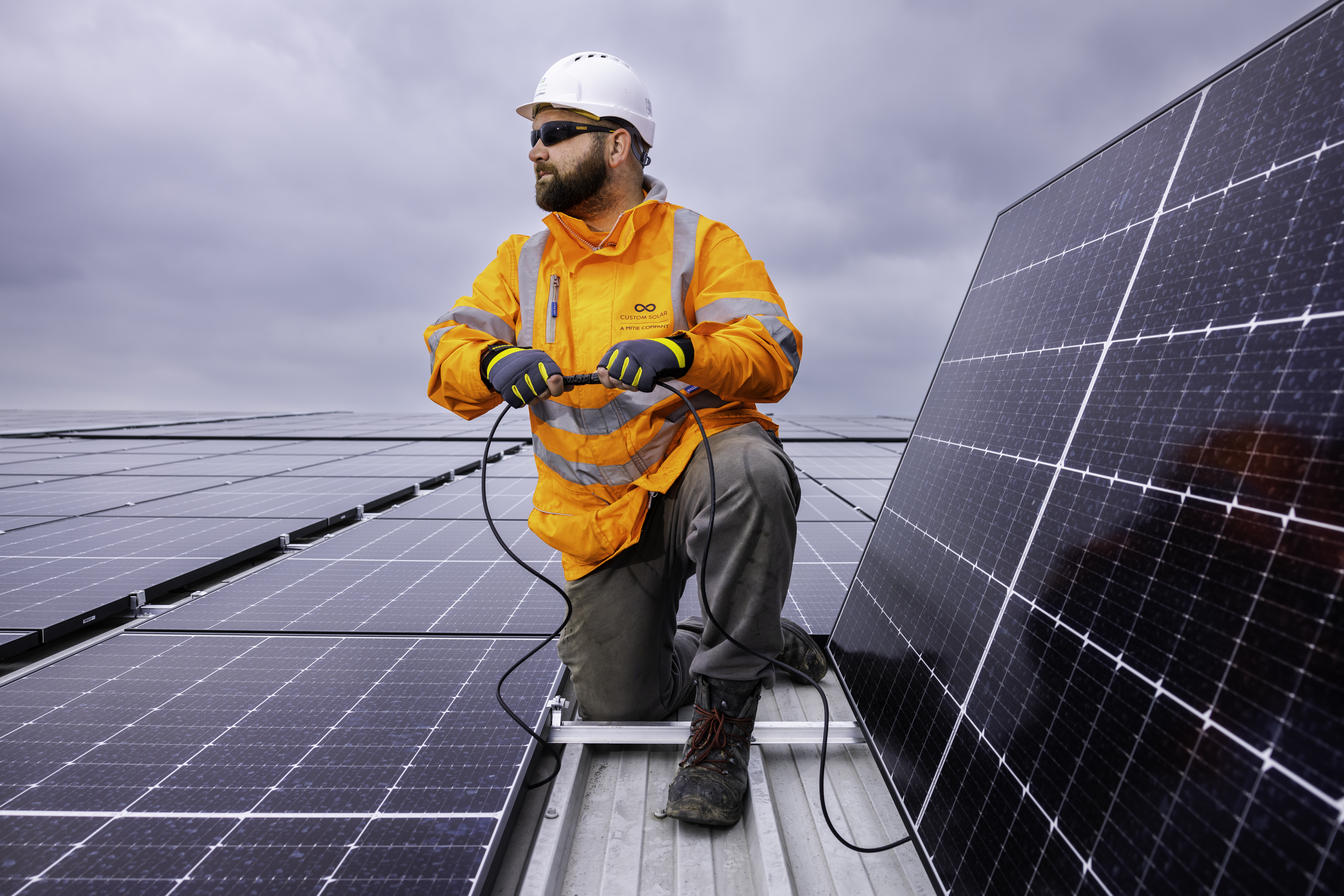 Custom Solar engineer installing a panel