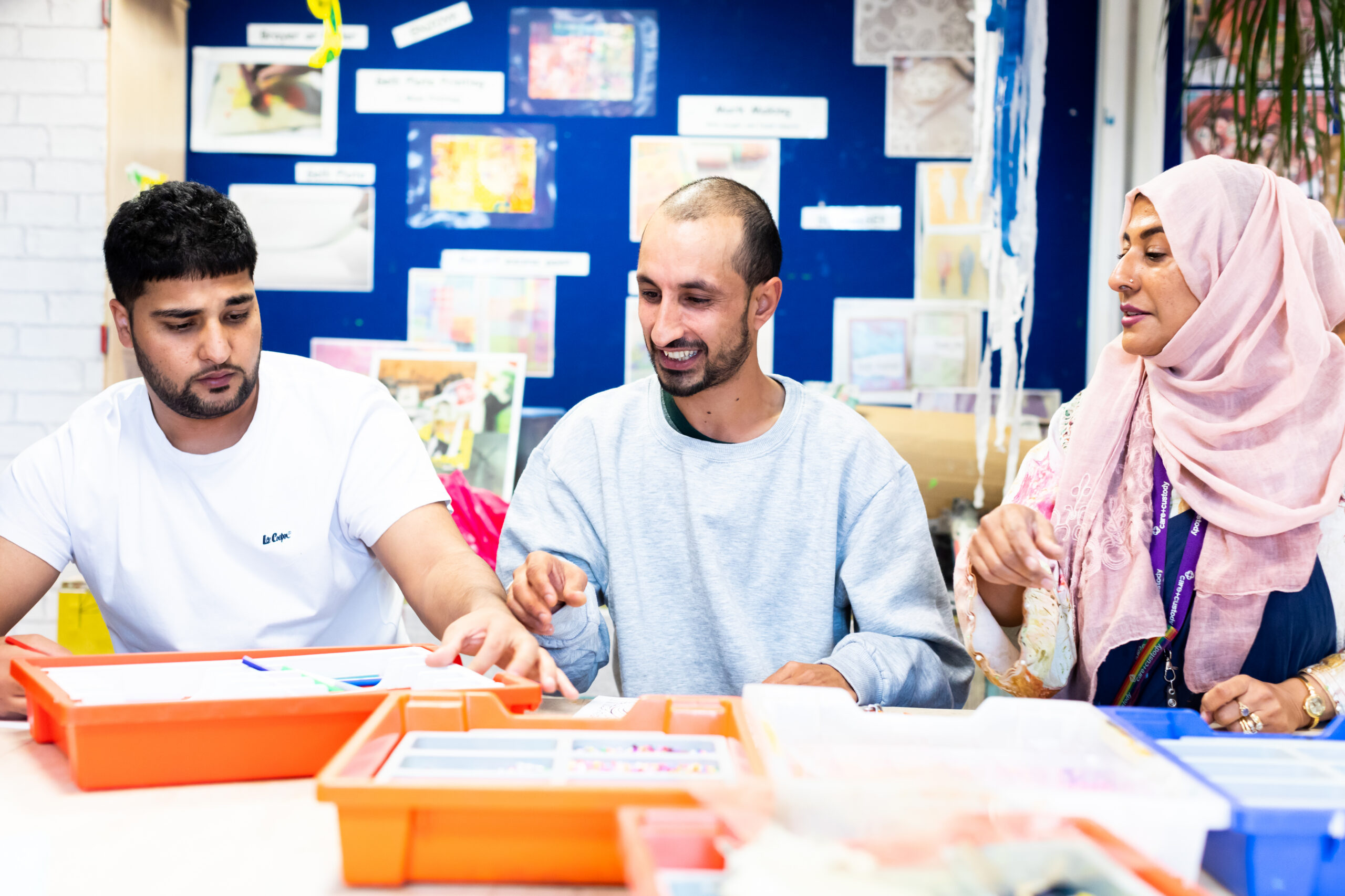 People doing arts and crafts in an immigration centre