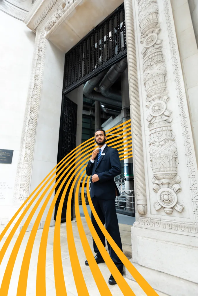 A Mitie security guard with a yellow wavy line curling around him