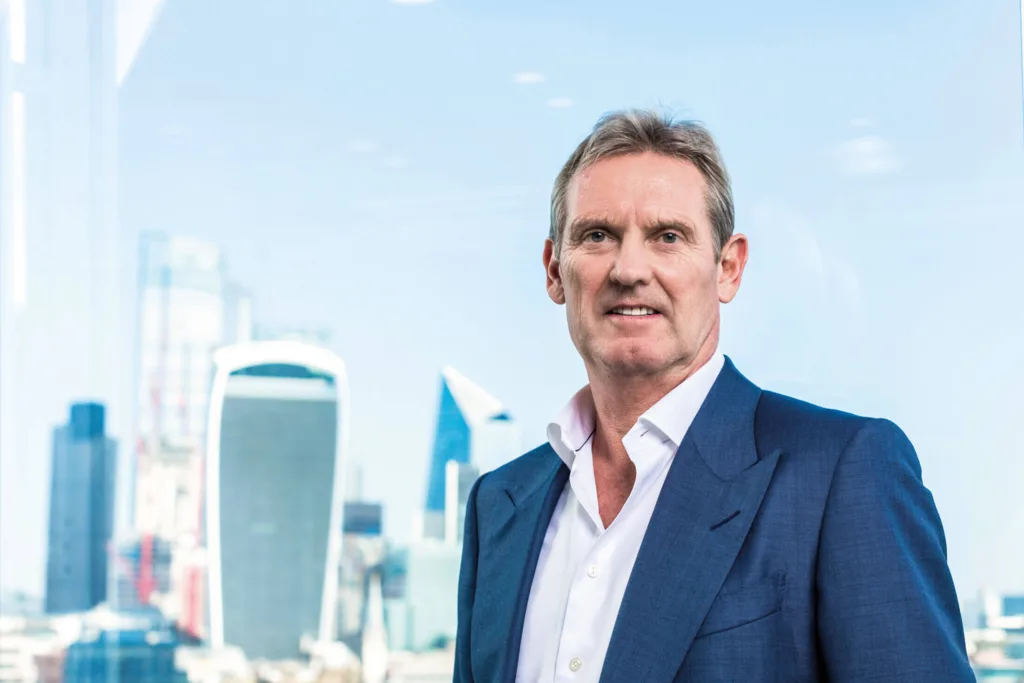 Phil Bentley, CEO of Mitie, looking into the camera with London cityscape in the background