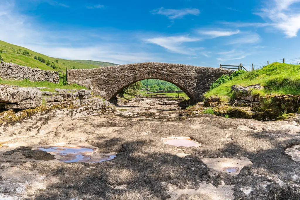 Dry river bed under a bridge