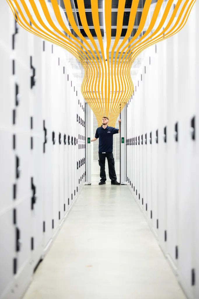 A data centre work with a yellow wavy line rising above him