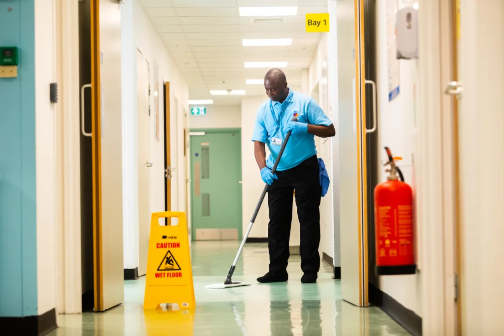 Hospital cleaner mopping a floor
