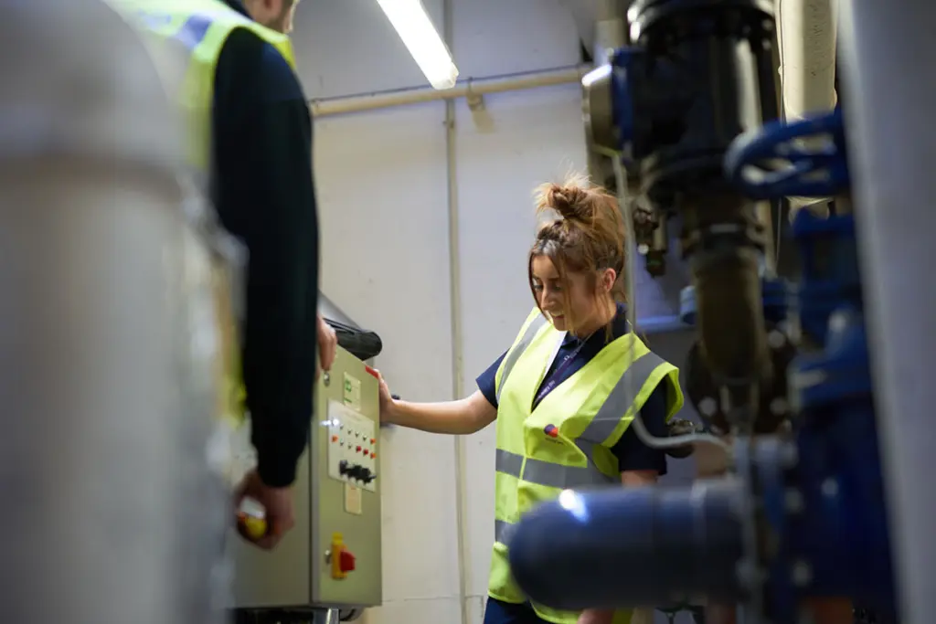 Engineering apprentice by a machine