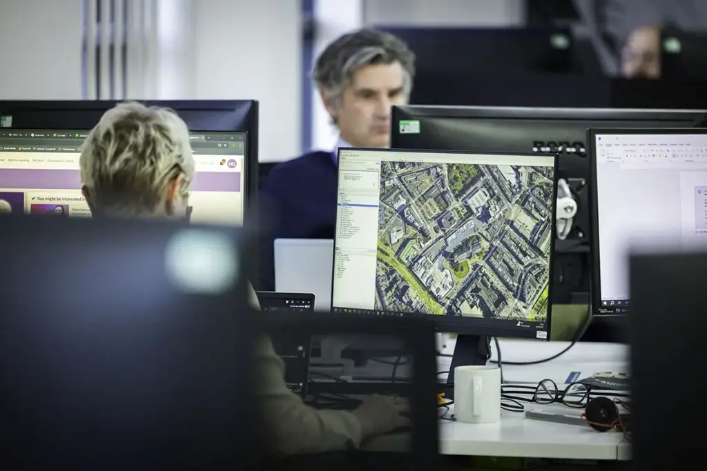 Mitie Intelligence agent reviewing maps on screens