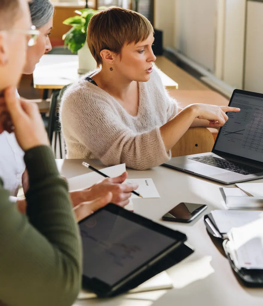 Female executive showing data to team in meeting