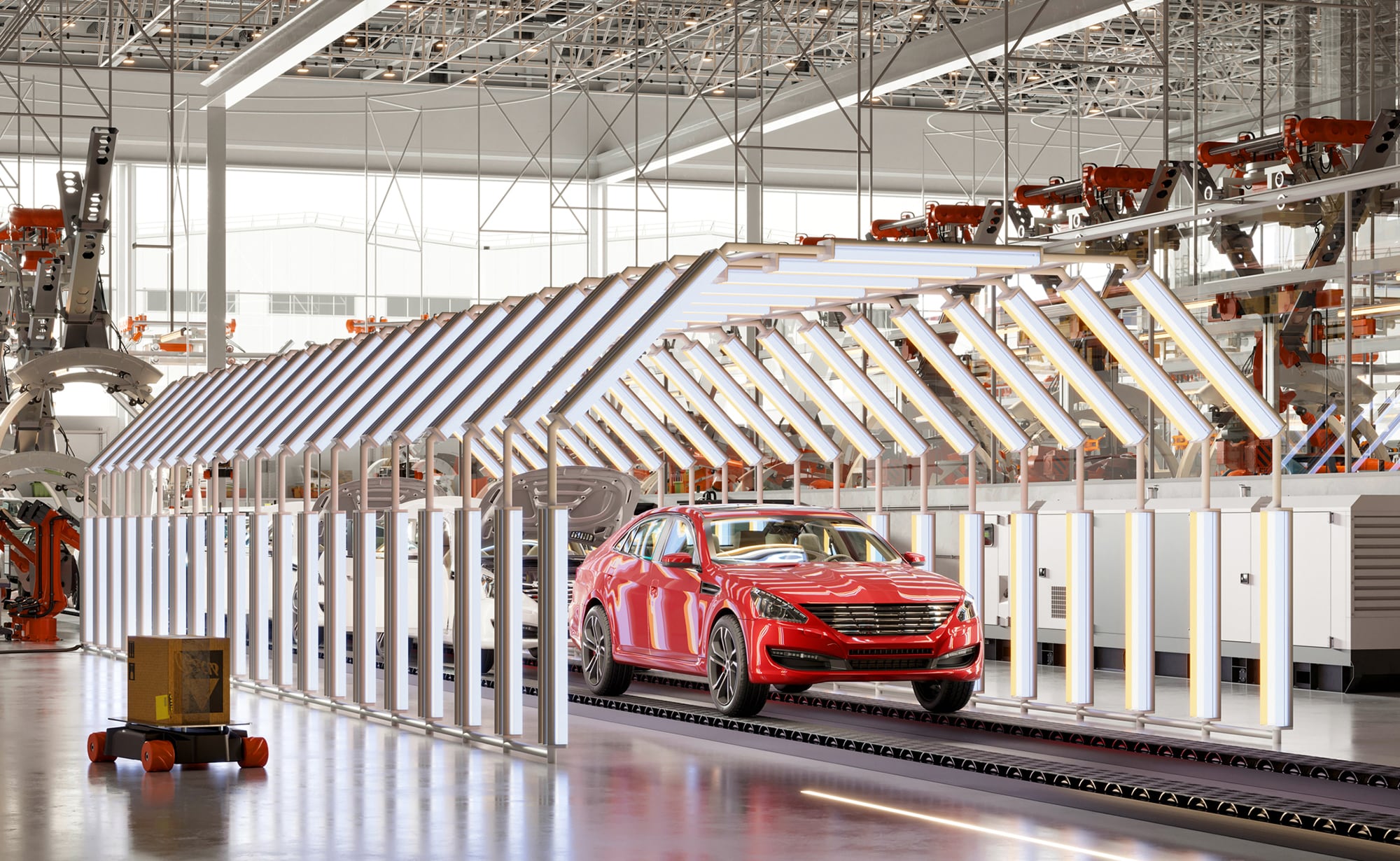 Red car on an automated production line in a vehicle manufacturing facility.