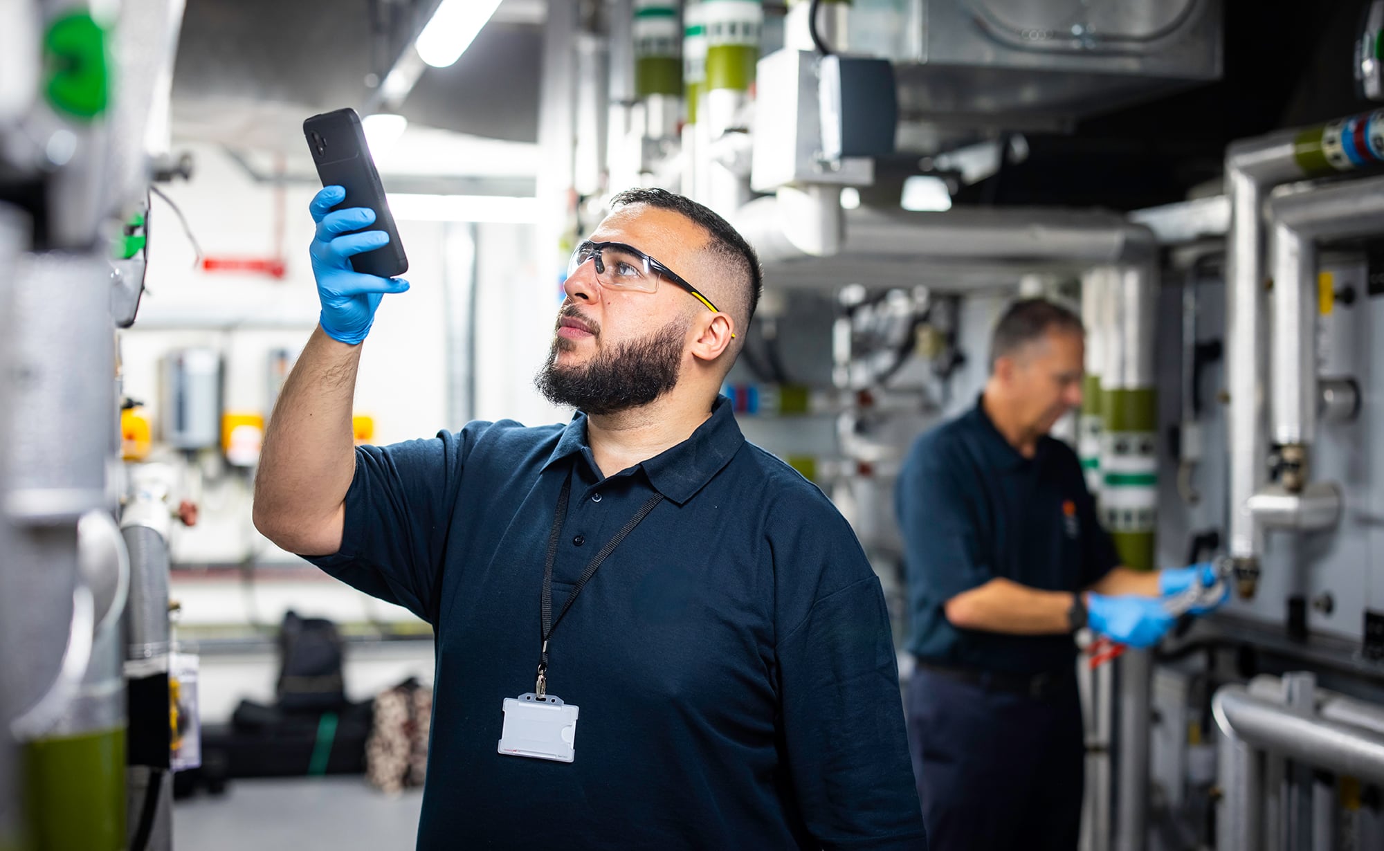 Engineer inspecting equipment in a plant room.