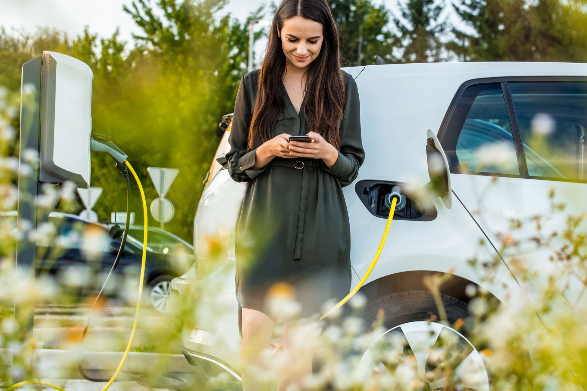 Woman charging an electric car.