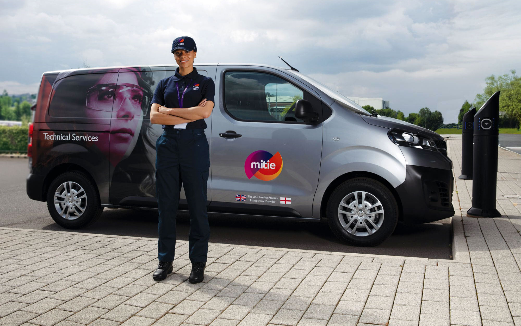 Mitie worker standing in front of van.
