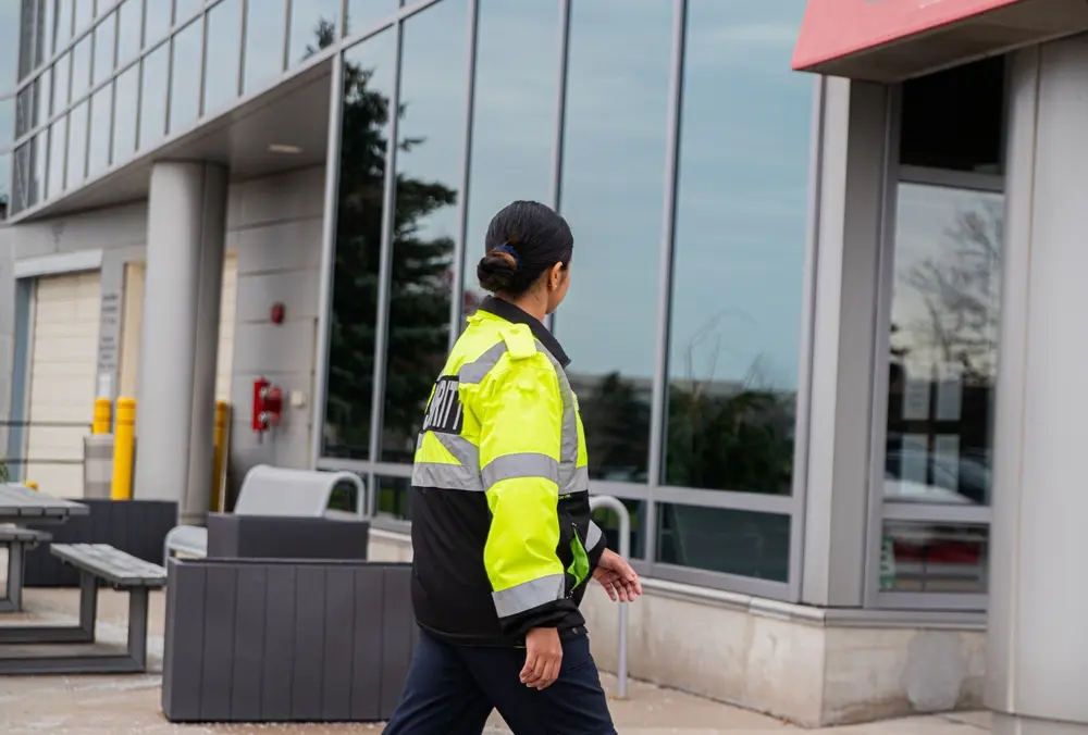 Female security guard outside a building