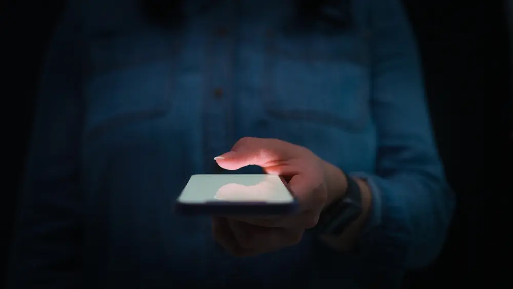 Close-up of a person's hand using a smartphone