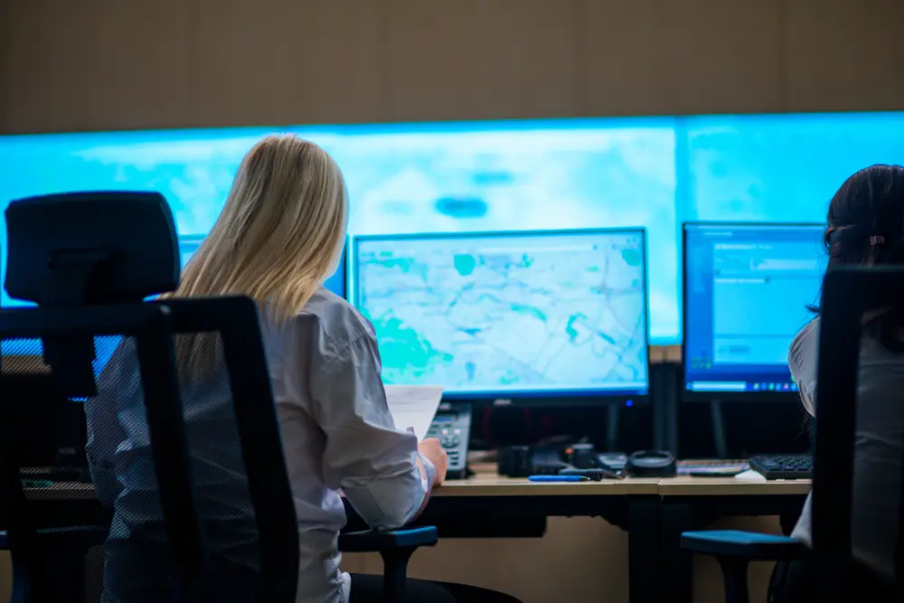 Security intelligence officer reviewing maps on a computer screen