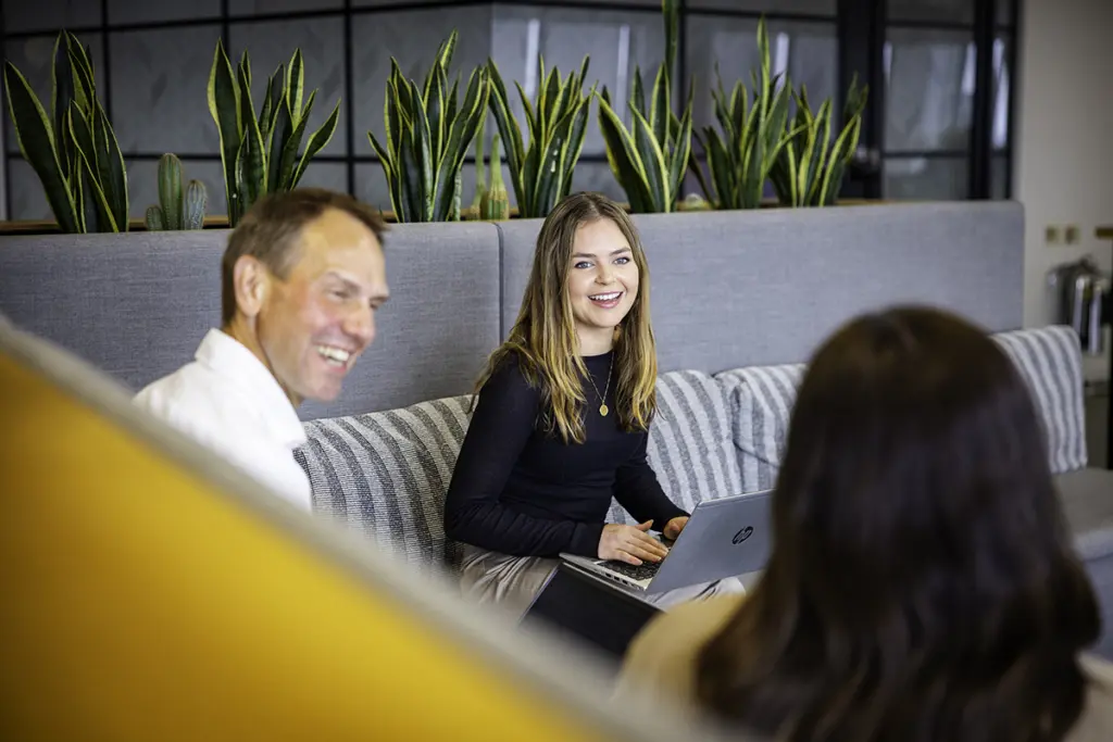 People laughing in an open-plan office space