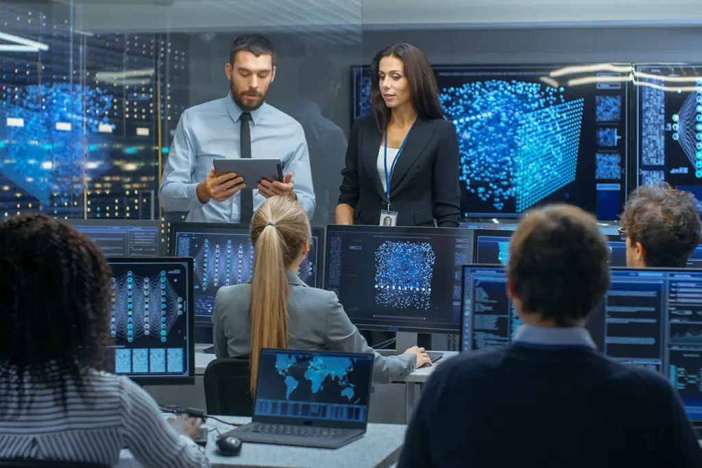 Security team examining data on digital screens