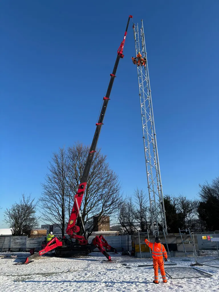 Telecoms mast being built by a railway